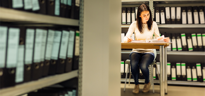 A photo of a researcher in the archive